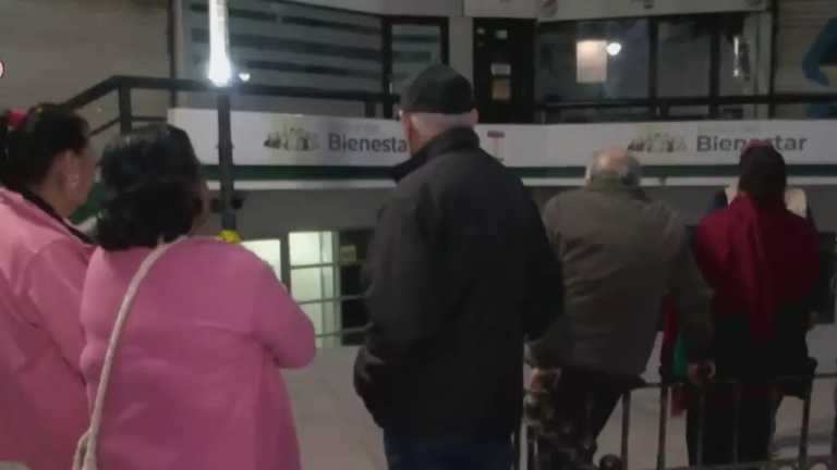 Adultos mayores madrugan para poder cobrar su pensión en banco bienestar del centro de Monterrey.